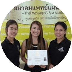 Three women holding a certificate in front of a green backdrop.