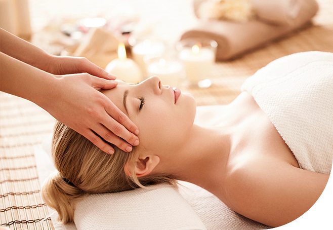 A woman getting her head washed by a masseuse.