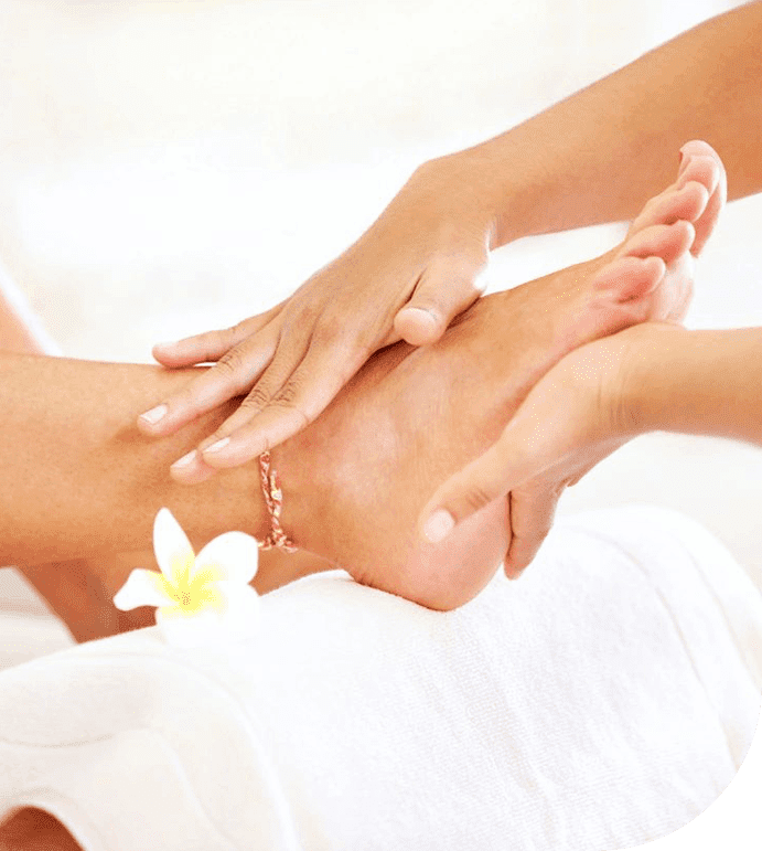 A woman is getting her foot massage