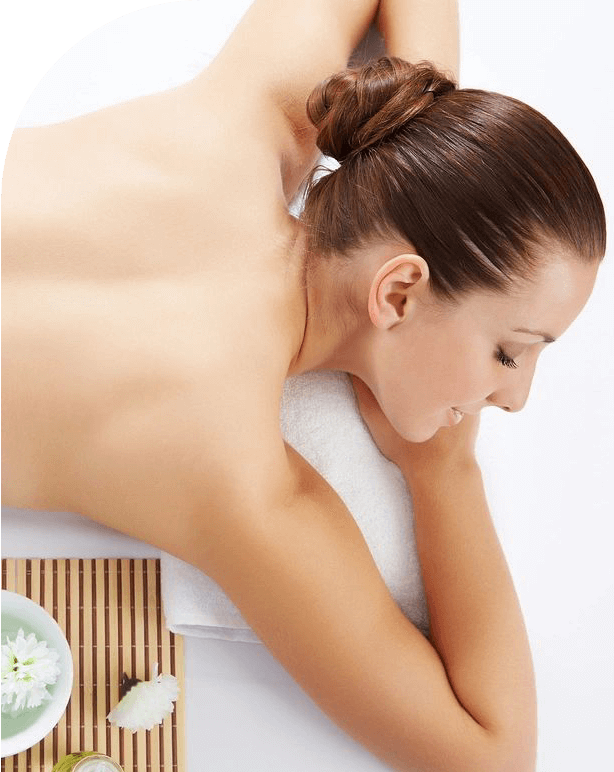 A woman is getting her back massage in the spa.