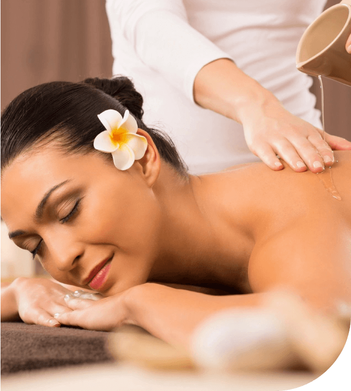 A woman getting her back massage done by a masseuse.