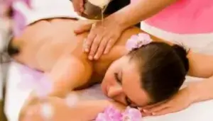A woman getting a massage with oil on her back.