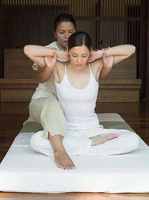 A woman is getting her legs stretched out