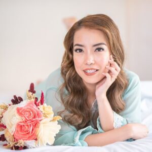 A woman laying on the bed with flowers